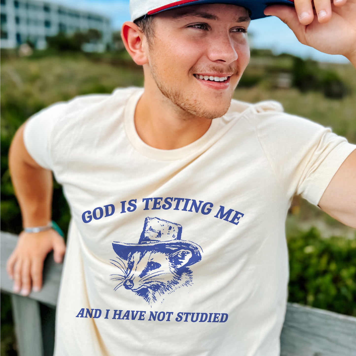 Funny Faith Shirt – God Is Testing Me and I Have Not Studied – Raccoon Meme Christian Tee – Natural – Up To 5XL