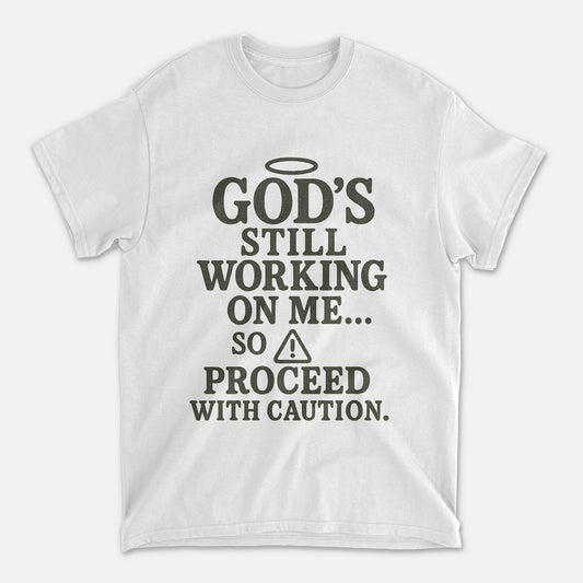 God’s Still Working On Me So Proceed With Caution T-Shirt   -  Funny Jesus Shirt For Christians- White- Up To 5XL
