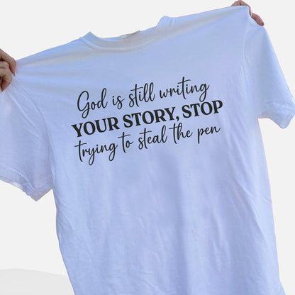God Is Still Writing Your Story – Stop Trying To Steal The Pen T-Shirt   -  Funny Jesus Shirt For Christians- White- Up To 5XL