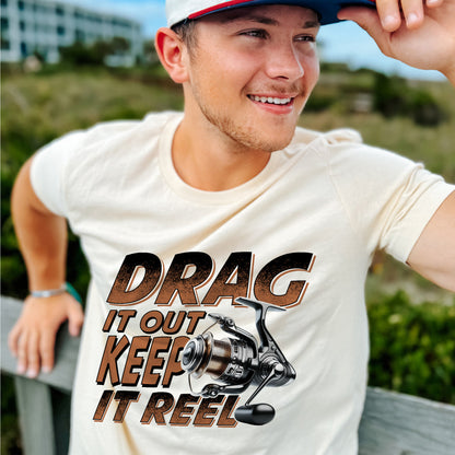 Fishing Pun Shirt – Drag It Out Keep It Reel Tee – Funny Angler Gift for Fishermen – Natural – Up To 5XL